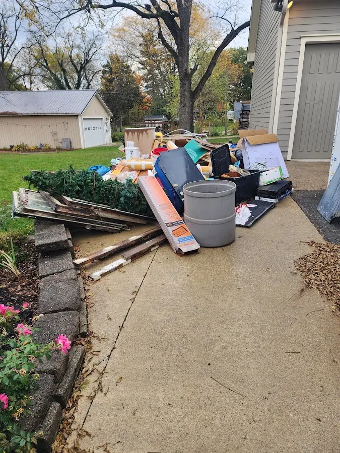 Dumpster being loaded with debris for Roofing Dumpster Rental in Saginaw